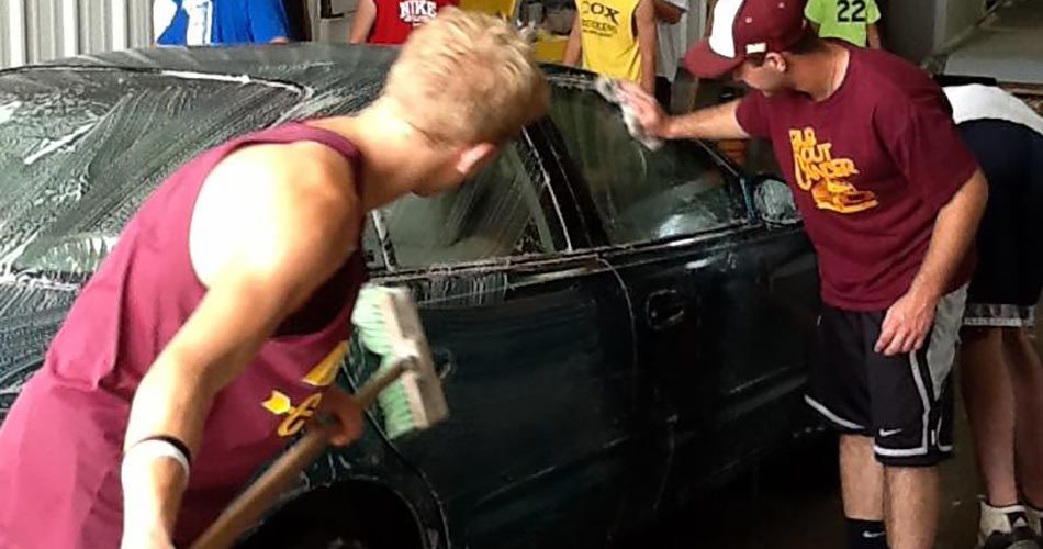 high school students washing a car at Probst Auto Body