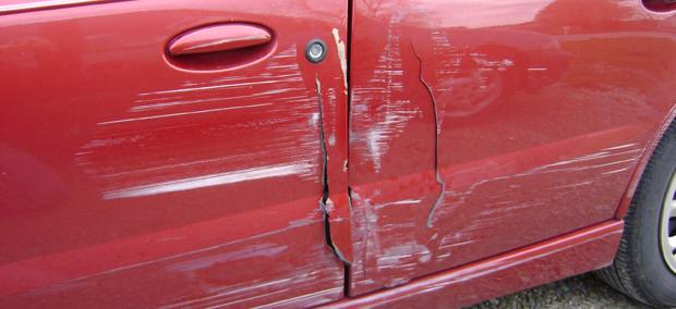 A photo of a driver-side door before we repaird the damage
